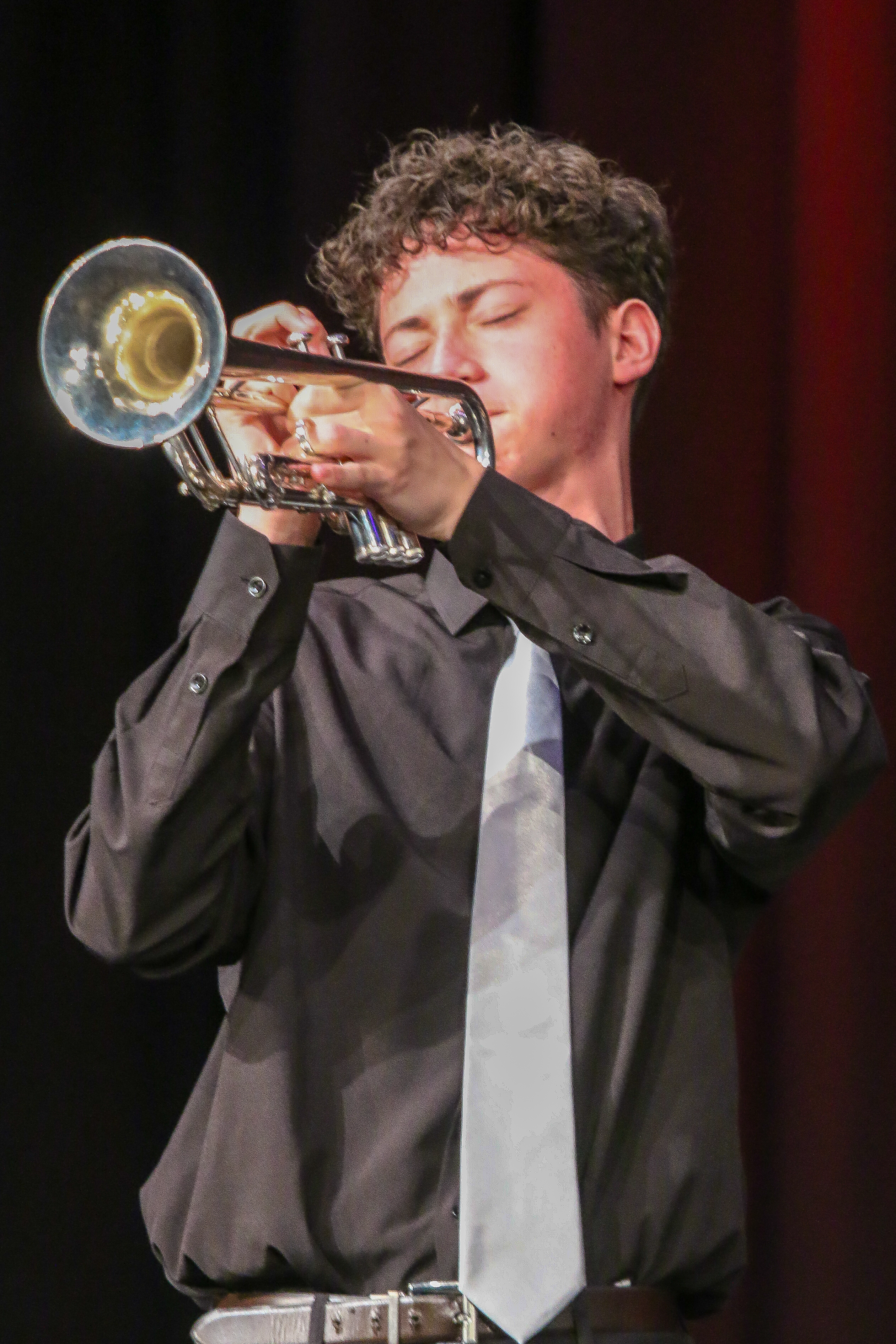 Alex Reinoso performing trumpet on stage